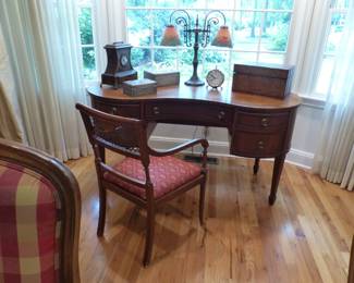 Kidney shaped desk, desk chair, lamp, bric-a-brac