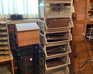 Stackable plastic storage basket bins full of clip boards