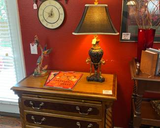 Elegant side chest with three drawers . You’ll find a nice collection of lamps & wall decor in this home. 