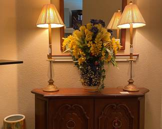 Retro console, matching lamps, mirror and floral arrangement 