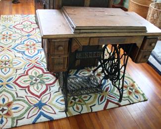 Antique Singer sewing machine in table