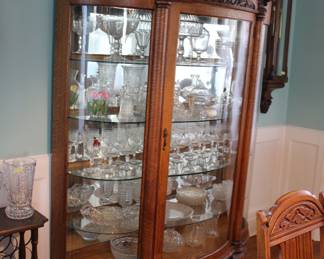 Antique tiger oak paw foot cabinet with carved wind faces