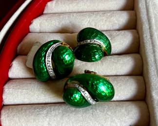 18 karat yellow gold ring and matching earrings.  The tops have a hard fired green enamel coating.  The ring has 12 single cut diamonds set in a white gold strip down its center.  Each earring also has a matching white gold strip with nine diamonds in each.  The are a mix of single and round brilliant cuts.  Total diamond weight is approximately 1/2 carat.  The earrings have omega backs.  The estimated replacement value of this set is $4400.00.  Appraised by Korona Jewelry Buffalo NY.