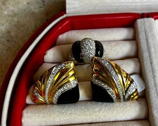 18 karat yellow gold onyx and diamond woman's ring.  It contains 60 round brilliant diamonds that are pave set.  They are eye clean and near colorless.  The total diamond weight is approximately 2.5 carats.  the ring also contains two pillow shaped pieces of onyx.  Matching pair 18 karat yellow gold, platinum and onyx earrings.  The onyx is at the bottom and takes up approximately 1/3 of the face.  Each earring also contains 3 platinum strips with 40 round brilliant diamonds of graduated sizes.  They are eye clean and near colorless.  The total weight of the diamonds in both earrings is approximately 1 carat.  The estimated replacement value of these earrings is $5000.00.  Appraised by Korona Jewelry Buffalo, NY