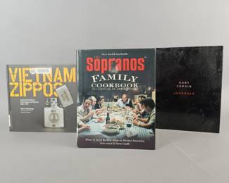Lot 308 | Vietnam Zippos Hardcover Book and More