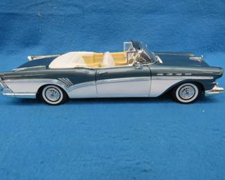 Lot 155. Motor Max 1957 Buick Roadmaster. 1:18 scale die-cast car. Includes plastic display box and sleeve. Passenger side rearview mirror is detached.