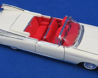 Lot 58. Maisto 1959 Cadillac El Dorado Biarritz 1:18 scale die-cast with original box and plastic display case
