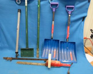 Lot 131. Edger, two trunk-sized snow shovels, electric trimmer, paint stick, ice chisel, bar clamp, large tote