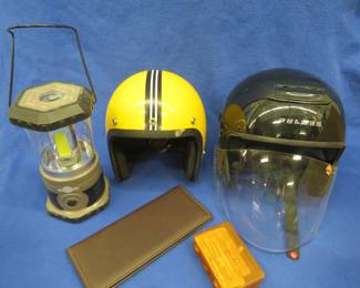 Lot 54. Two helmets and a battery-powered lantern