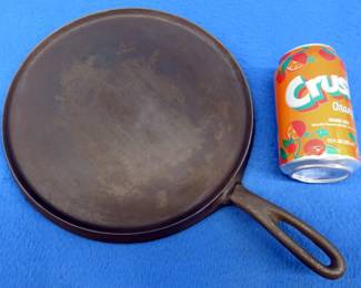 Lot 231. 9-inch cast iron "Favorite" Piqua Ware griddle.&nbsp; Smiley logo.