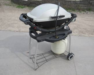 Lot 269. Webber grill with propane tank that is nearly full