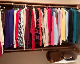 two closets full of sweaters shirts,  pants, robes all as new, most never worn. 