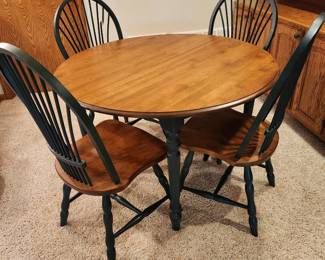Table and 4 chairs 29 x 45 dia, leaf 20 in wide (one chair has broken spindle) located in basement
