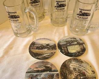 Four train themed stone coasters and glass mugs