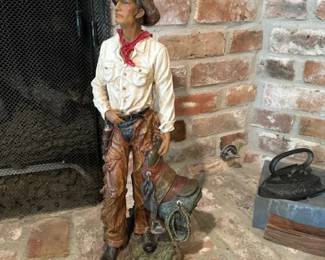 36" Tall Cowboy holding saddle.