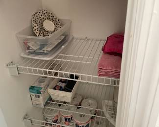 The bottom shelf is full of toilet paper