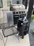 Grill (fair condition but still works fine)includes full propane tank metal side tables brand new smoker