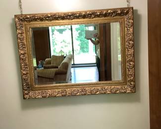 One of two heavy hanging gold frame mirror