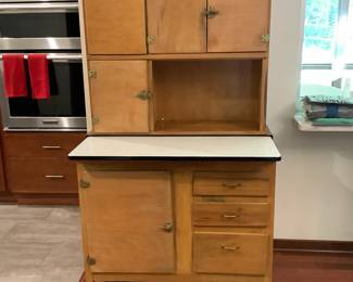 Antique Hoosier cabinet, complete with enamel top, authentic flour sifter, original hardware, legs and casters