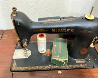 Vintage Singer sewing machine in cabinet
