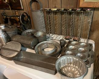 Vintage metal kitchenware; Kiwi shoe polish advertising/display stand; antique Singer sewing machine repurposed into a table lamp.