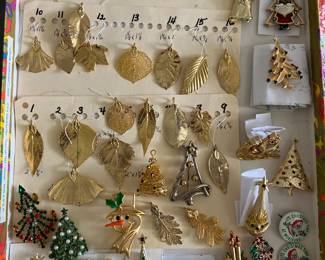 1,000+ pieces of vintage jewelry, including a large selection of gold-plated leaf pendants and many designer Christmas-/holiday-themed brooches and pins.