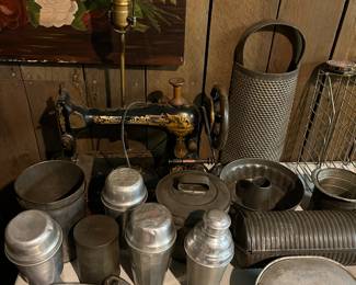 Vintage metal kitchenware; Kiwi shoe polish advertising/display stand; antique Singer sewing machine repurposed into a table lamp.