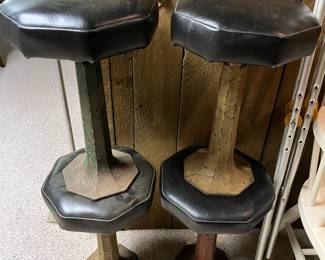 Four vintage ice cream parlor stools with metal bases.