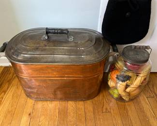 Vintage copper boiler; vintage lidded jar full of artificial fruit.