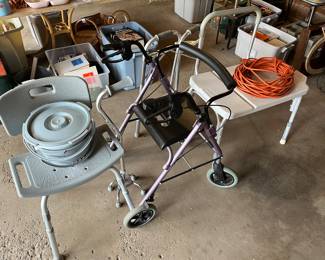 Infirmary equipment, including a Walker and a shower bench.