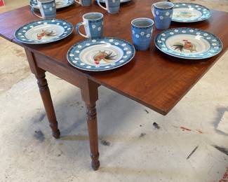 The dinner set for six on the folding wood table