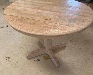 A nice round blonde wood dining table.