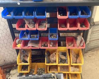 This storage stand has several containers of fasteners.