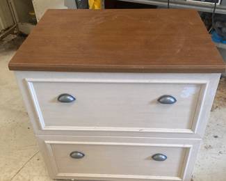 A particleboard storage cabinet with two drawers.