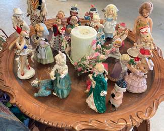 A beautiful antique round wood end table, and lots of antique figurines