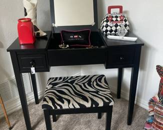 Black dressing table with mirror and bench, various accessories