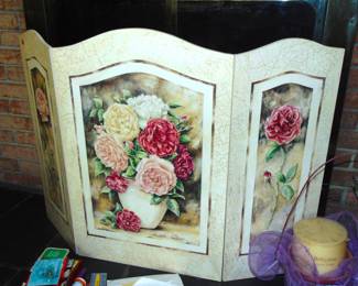 Painted fireplace screen with floral motif.
