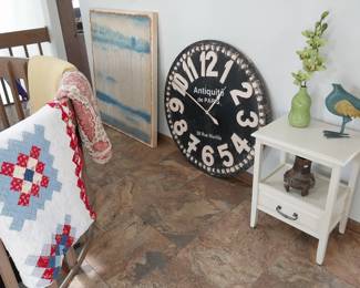 quilts, large wall clock, side table