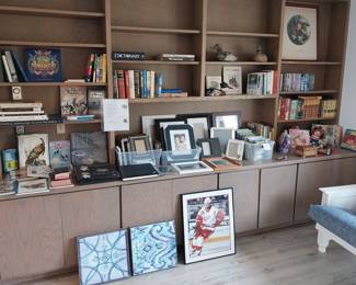 wooden duck decoys, picture frames, books, DVDs