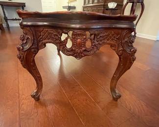 Side view of carved antique coffee table