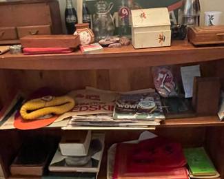 Bookshelf with Redskins items and more.