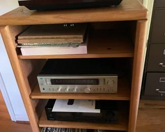 Entertainment shelf with stereo equipment and records.