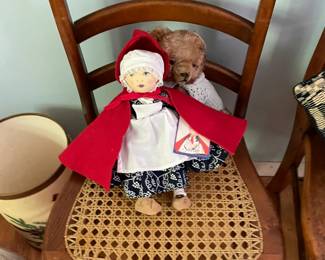 Child's chair with doll and teddy bear.