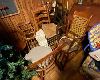 Large selection of antique wooden chairs.
