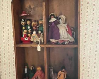 Shadow box with vintage dolls.