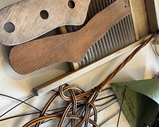 Antique washboard, carpet beaters, sock forms, dust pan. 