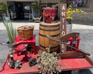 Rustic wine barrel, red Slat side tables, and 1950s tricycle - available now inside