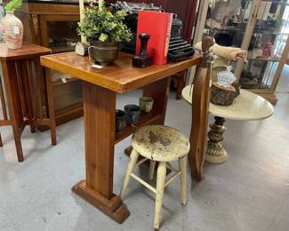 Antique farm stool, pedestal table, antique typewriter and Hollywood Regency round table are all available inside - now