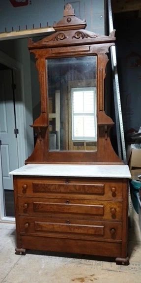 STUNNING ANTIQUE DRESSER. Priced to move . It has a hidden drawer. Very unique!