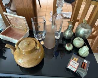 A beautiful black glass topped shelving unit willed with collectible smalls! 